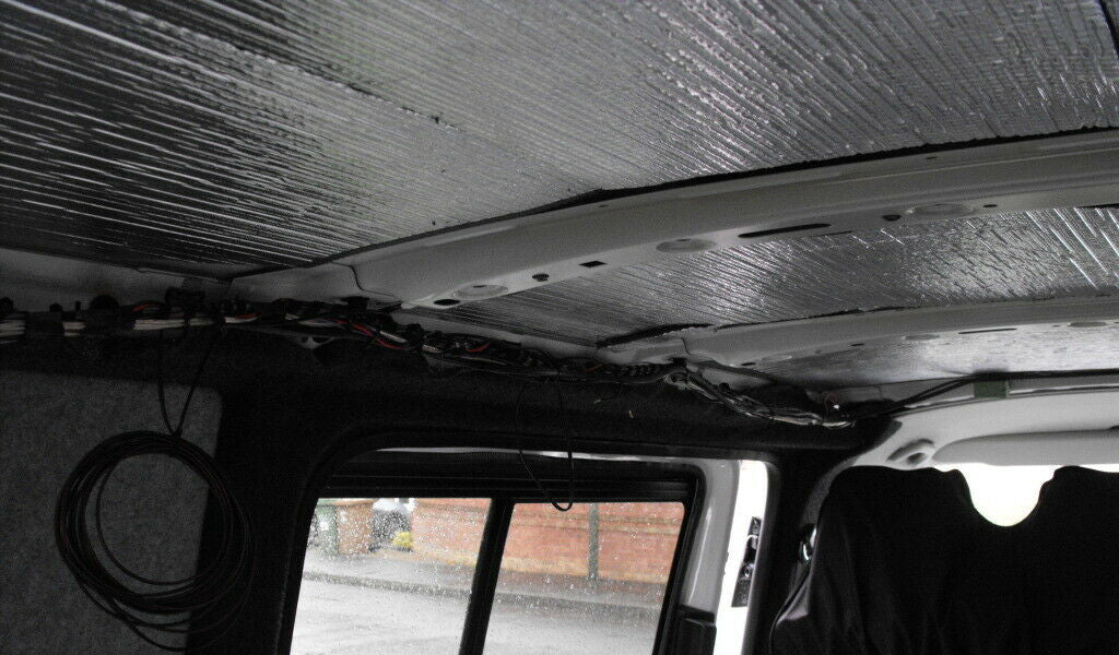 A close up of sound deadening insulation on the ceiling of a van.